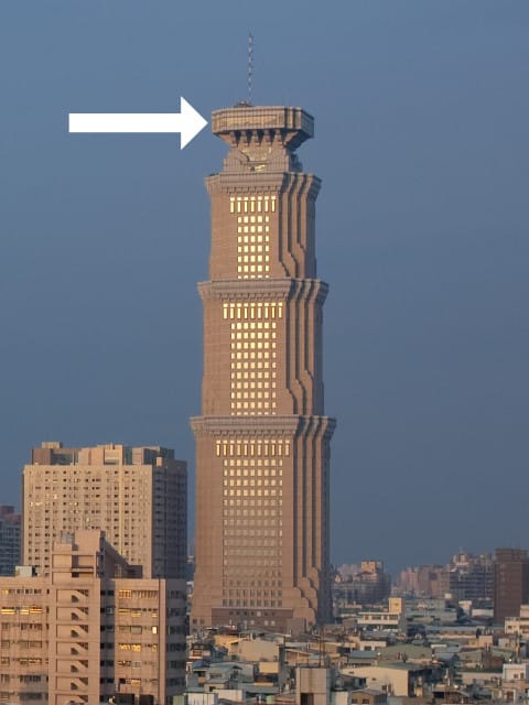 Exterior photo of Chang-Gu World Trade Center with a superimposted arrow pointing at the top floor.