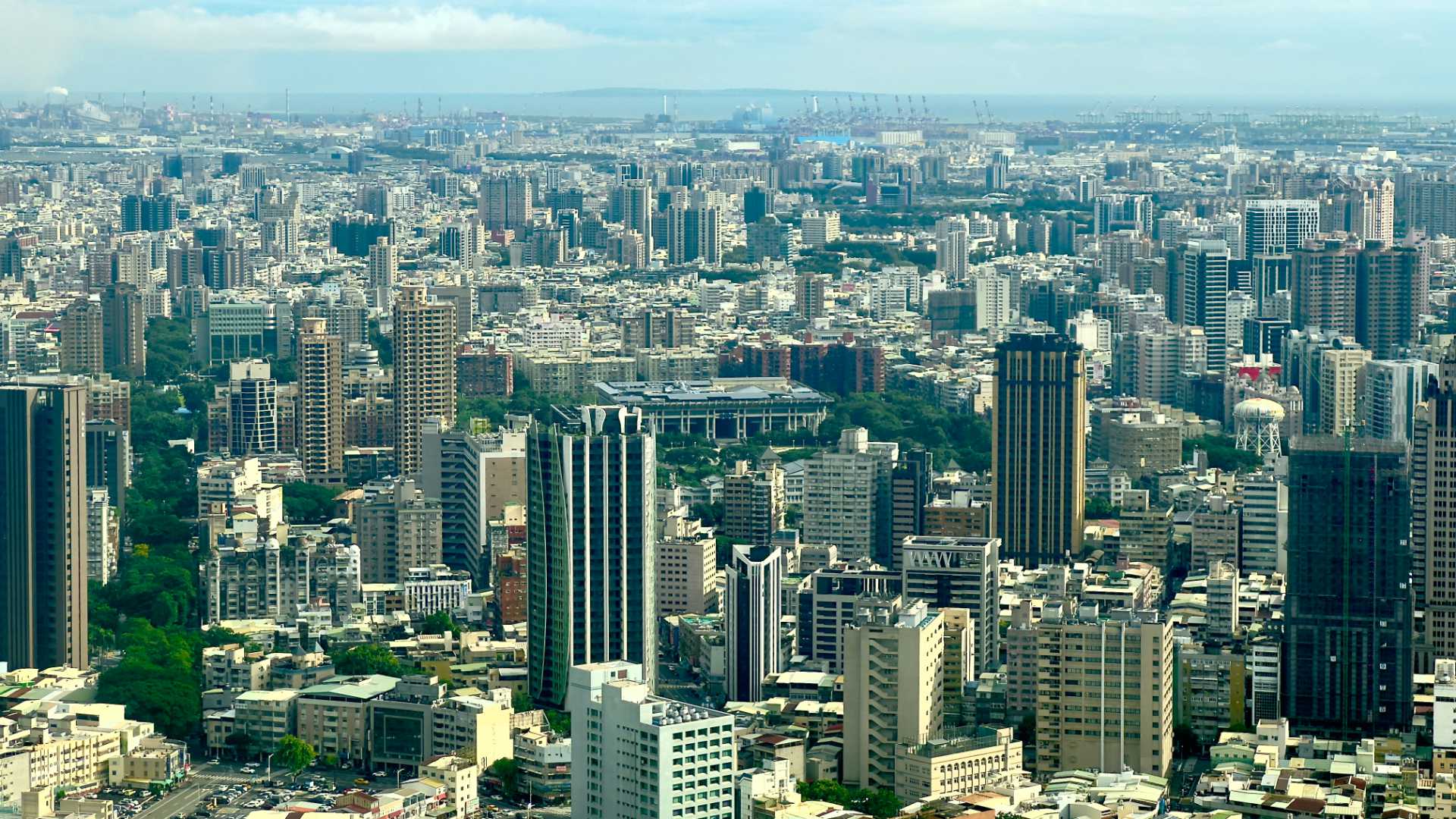 East view across Kaohsiung, taken from the 50th floor of the Grand 50 Tower. There are lots of high-rise apartment and office buildings in the foreground, and on the horizon, a small island.