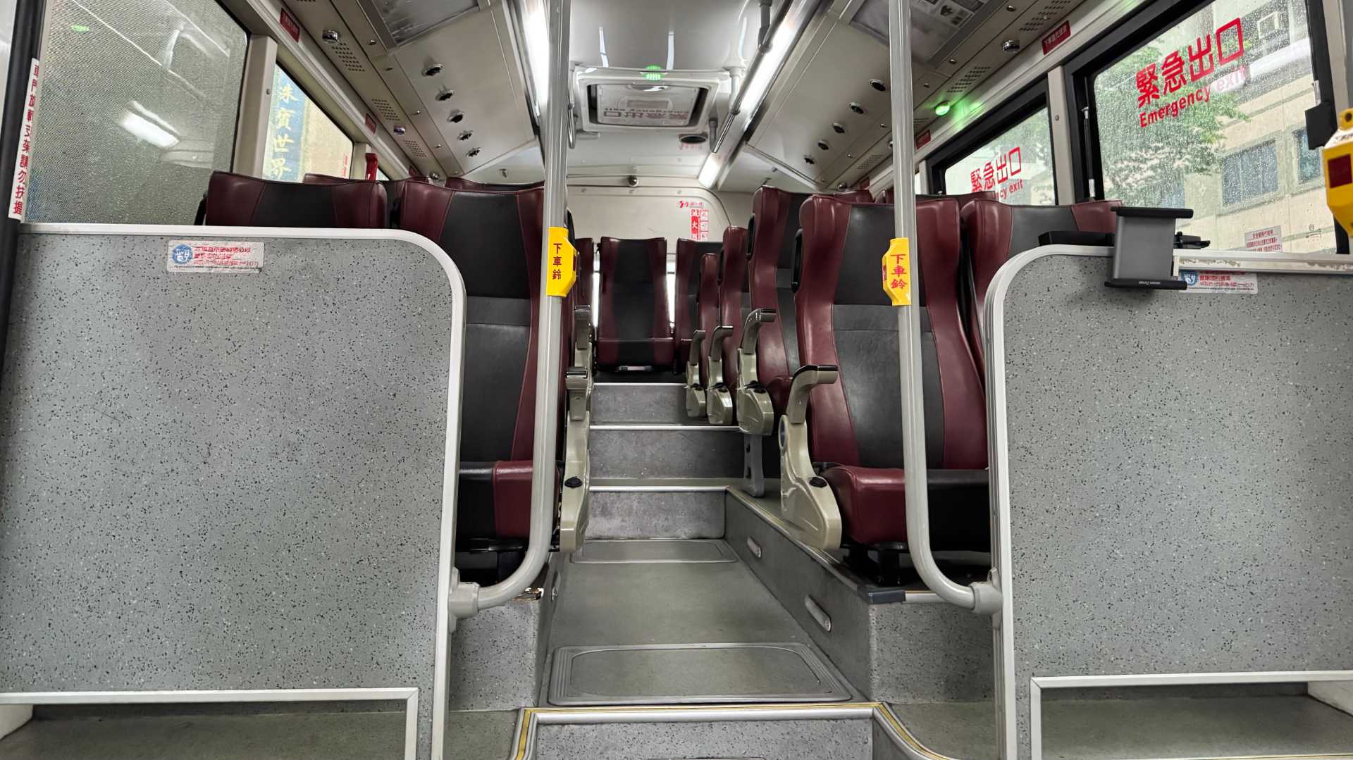 Interior of the elevated rear section of a bus in Kaohsiung, Taiwan. There are no passengers visible in the photo.