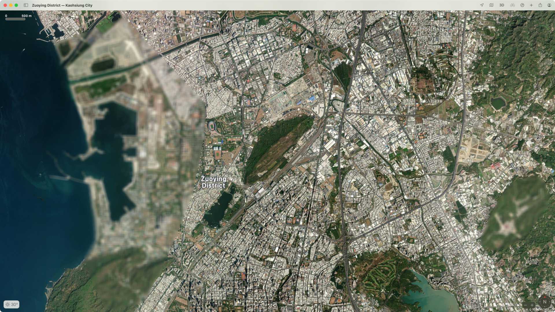 Screenshot of Apple Maps’ satellite view, showing the Zuoying and Niaosong districts of Kaohsiung, Taiwan—including blurred-out military facilities and Lotus Pond.