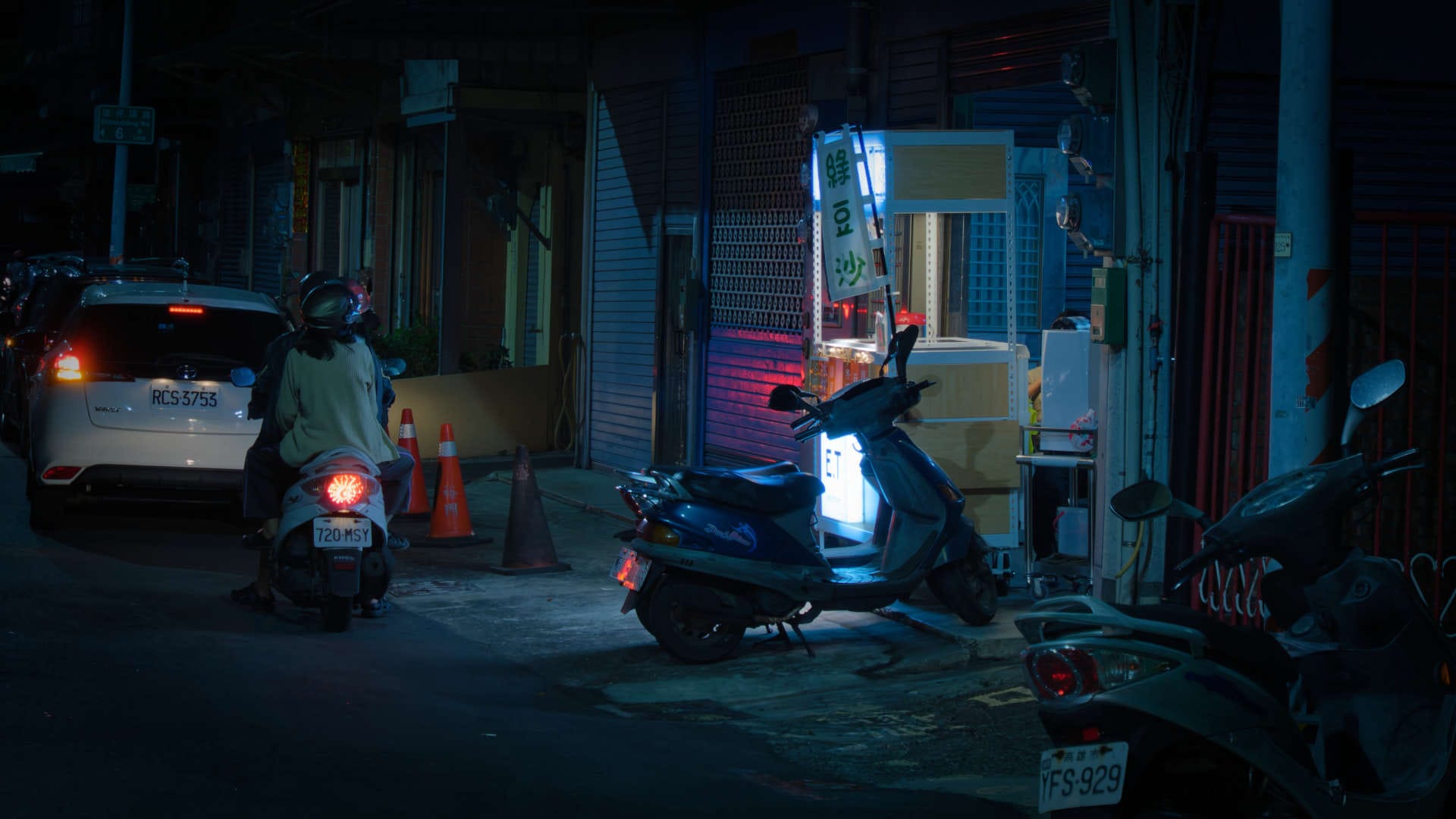 An illuminated tea stall in a dark side street in Zuoying District, Kaohsiung, Taiwan, at night.