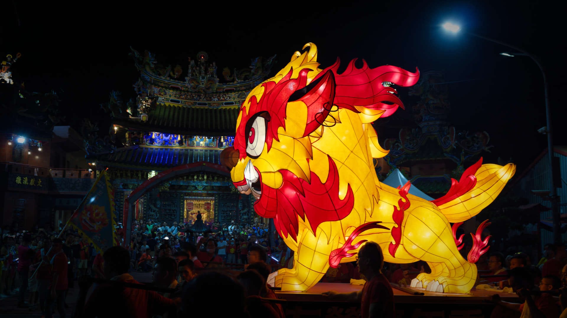 A huge Fire Dragon Lantern being carried towards a temple at night in Zuoying District, Kaohsiung, Taiwan.