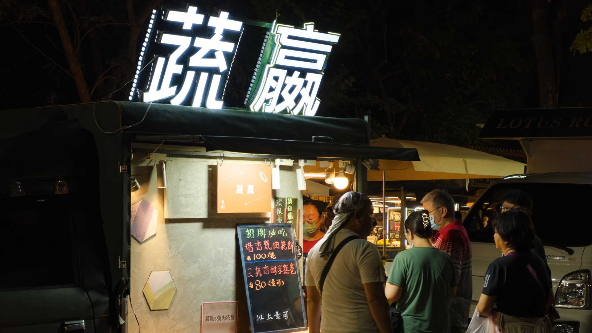 Five people queueing outside a food truck at the Kaohsiung Zuoying Ten Thousand Years Festival.