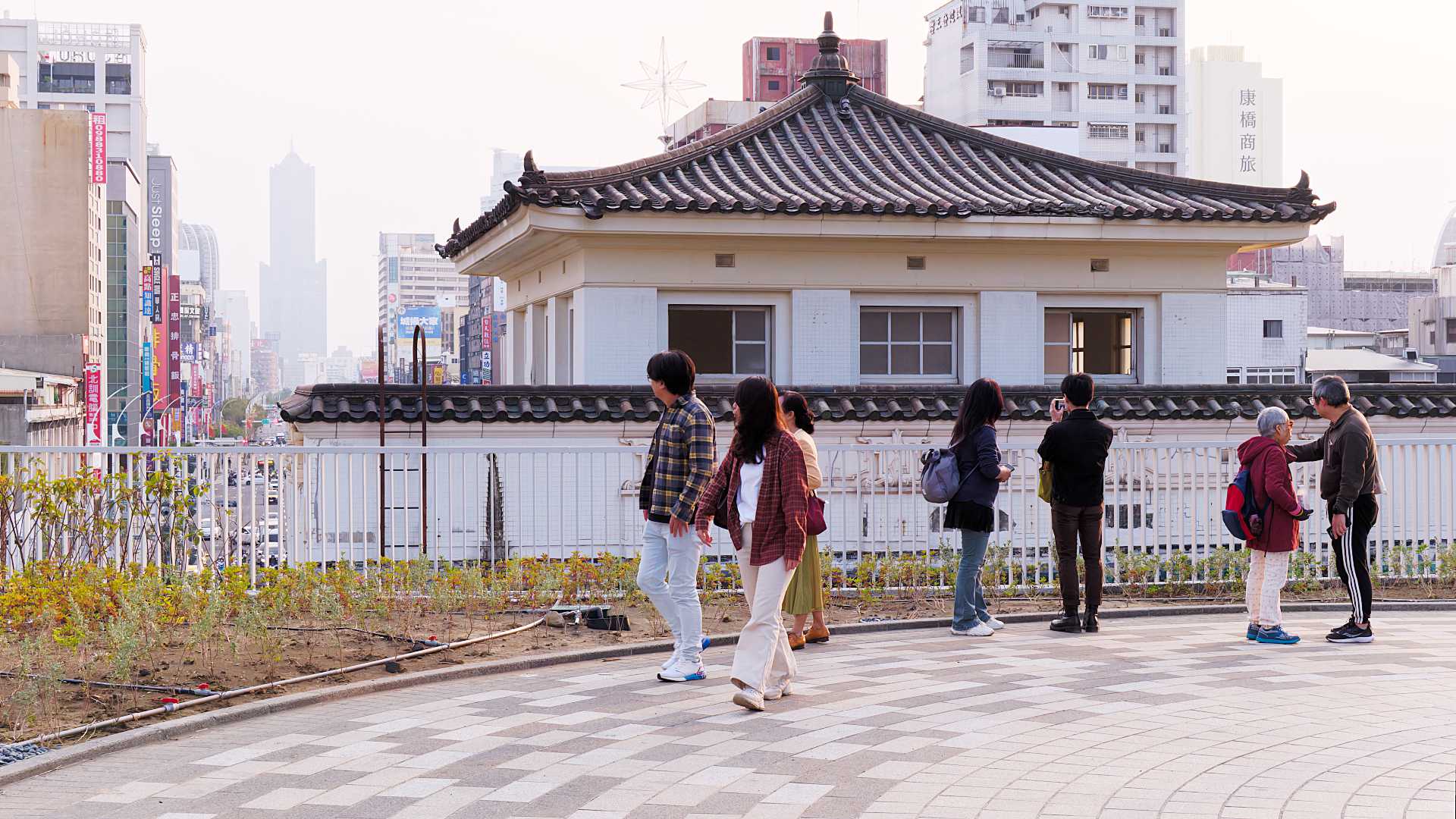 People walking past the upper floor of the old Kaohsiung Station.