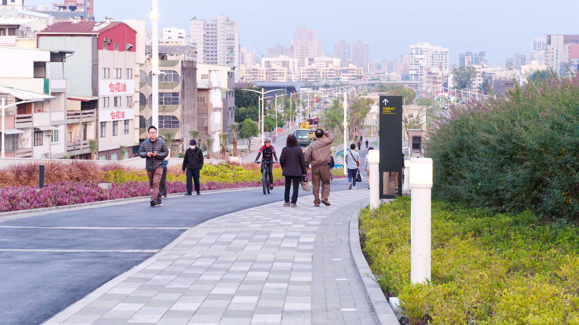 People walking downhill on the roof of Kaohsiung Station.