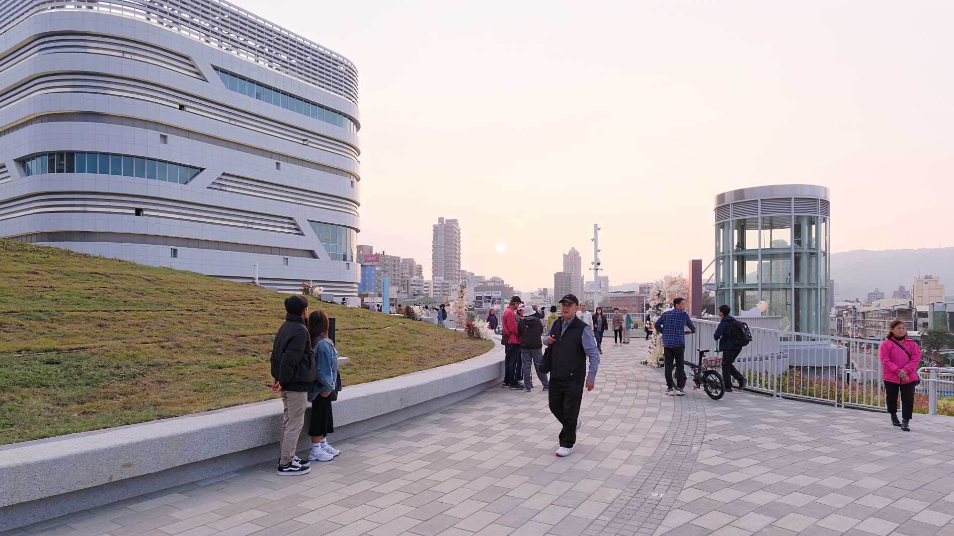 People strolling on the rooftop walkway at Kaohsiung Station.