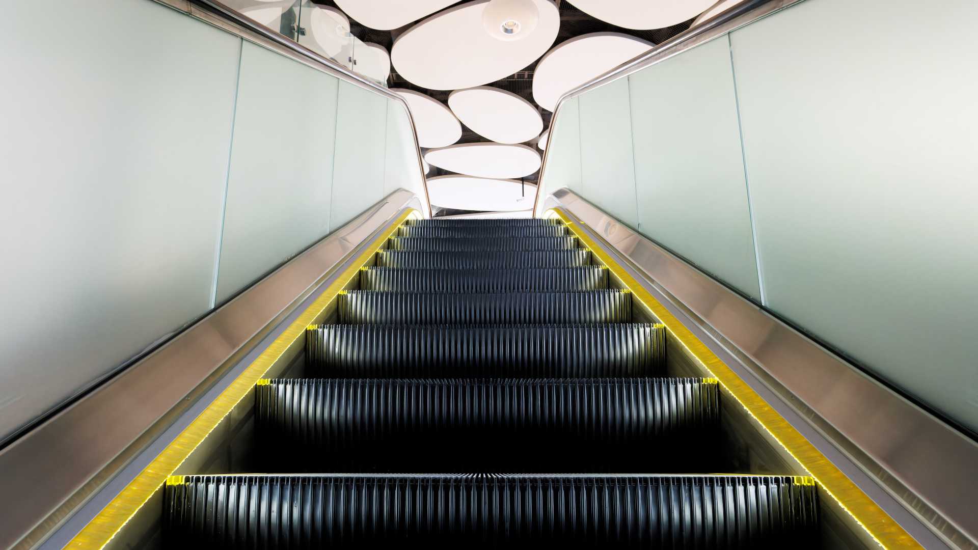 Abstract view of an escalator heading up towards ground level.