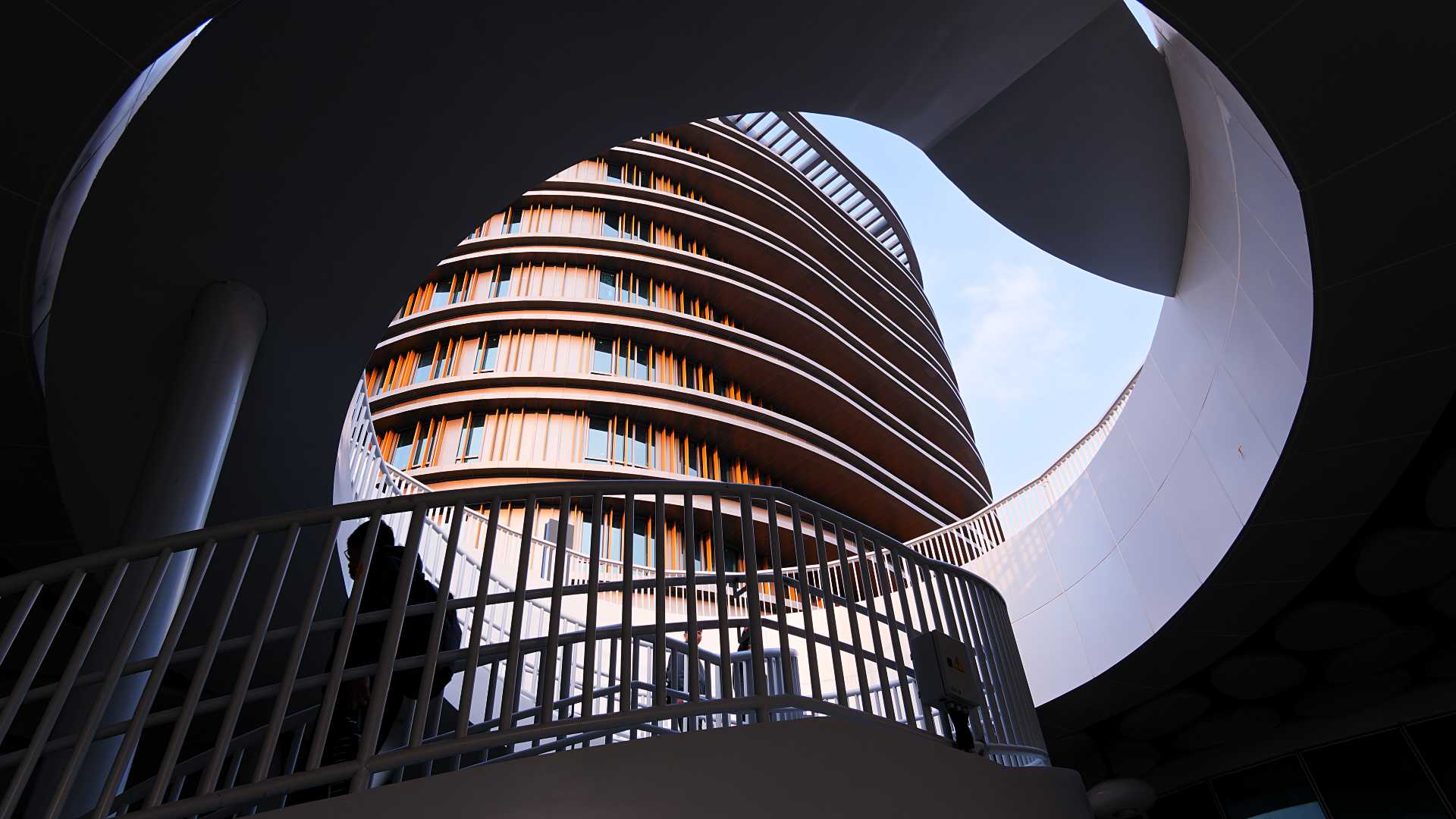 Oblique view of the new Kaohsiung Station hotel building, looking upwards over a spiral staircase.