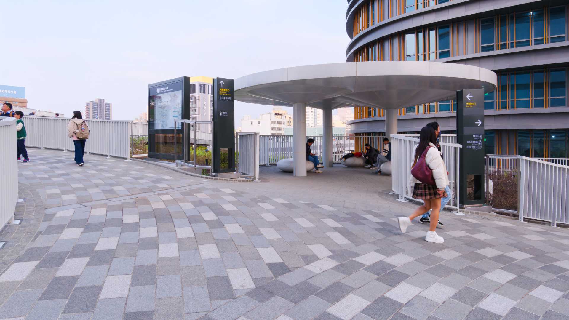 People sitting in the shade on the rooftop garden of Kaohsiung Station.