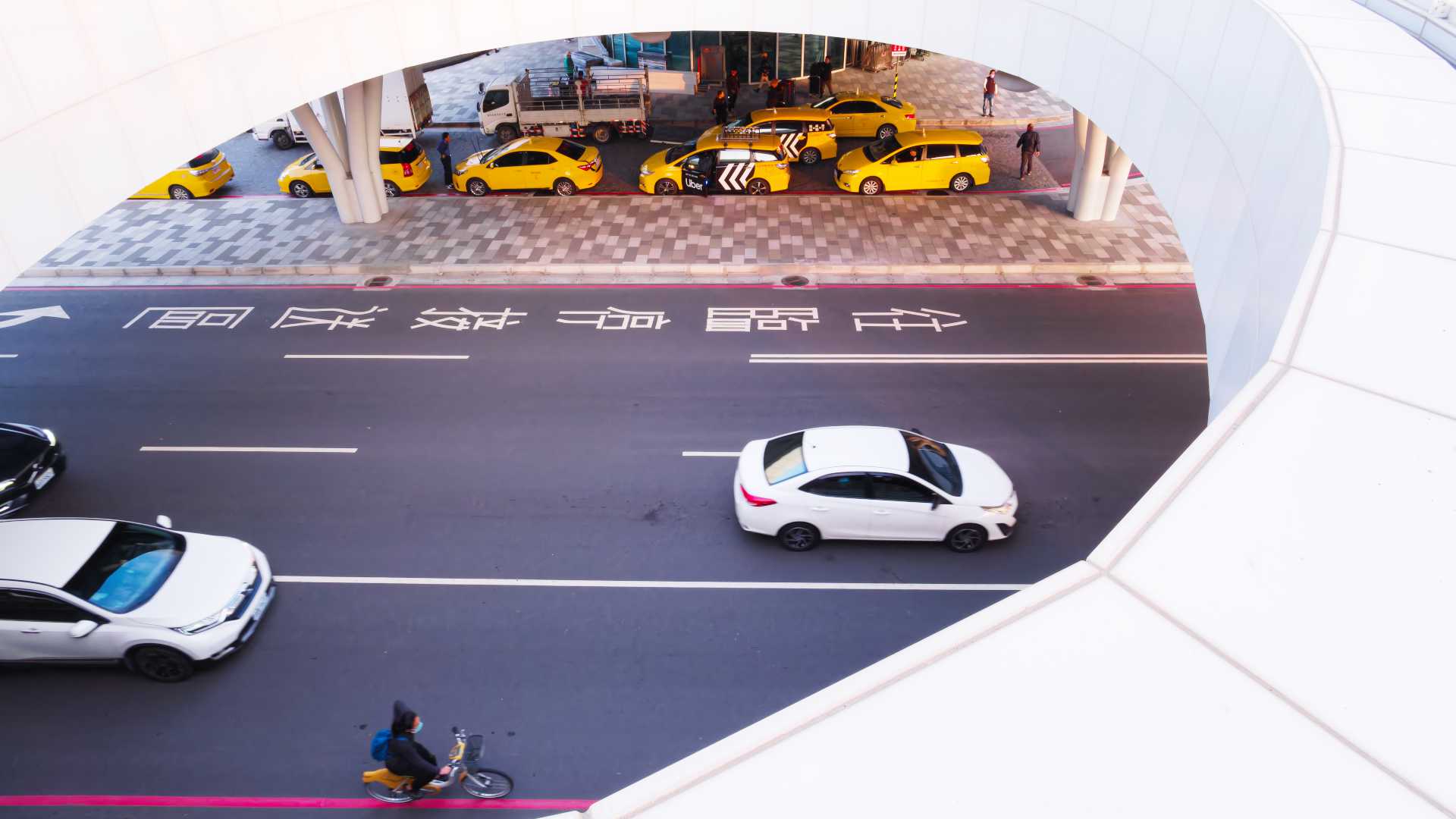 Taxis parked outside Kaohsiung Station, viewed from above.