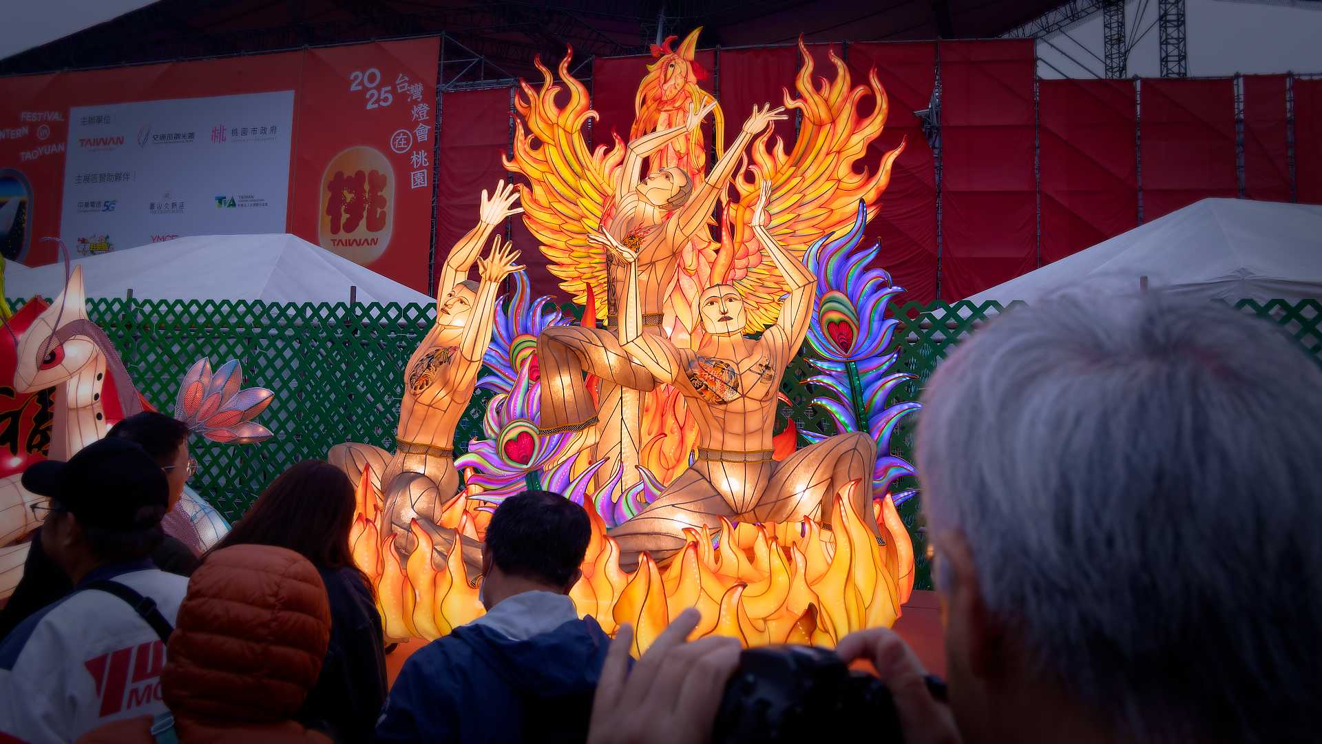 Lantern in the shape of people dancing in a fire.