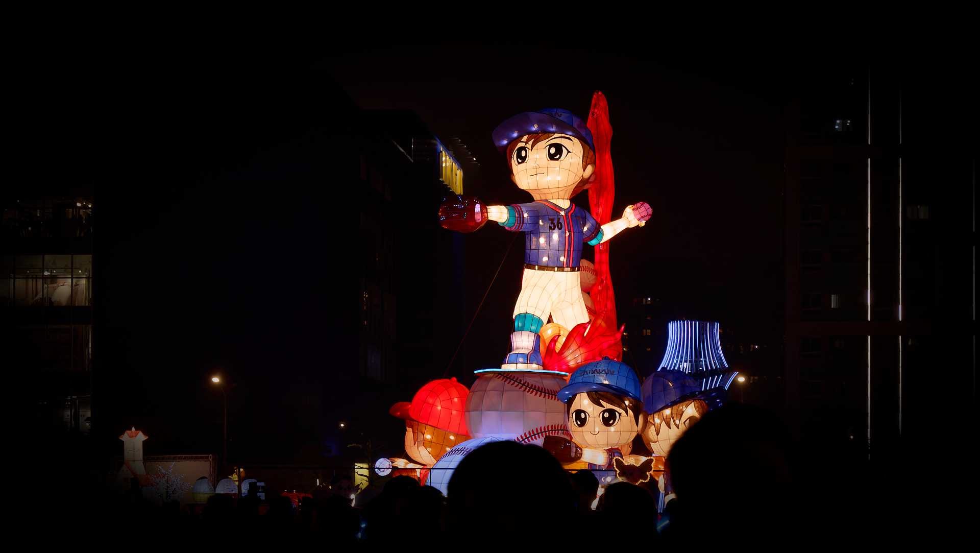 Lantern in the shape of a baseball pitcher, number 36, standing atop an oversized baseball, wearing a 'Taiwan' baseball cap.