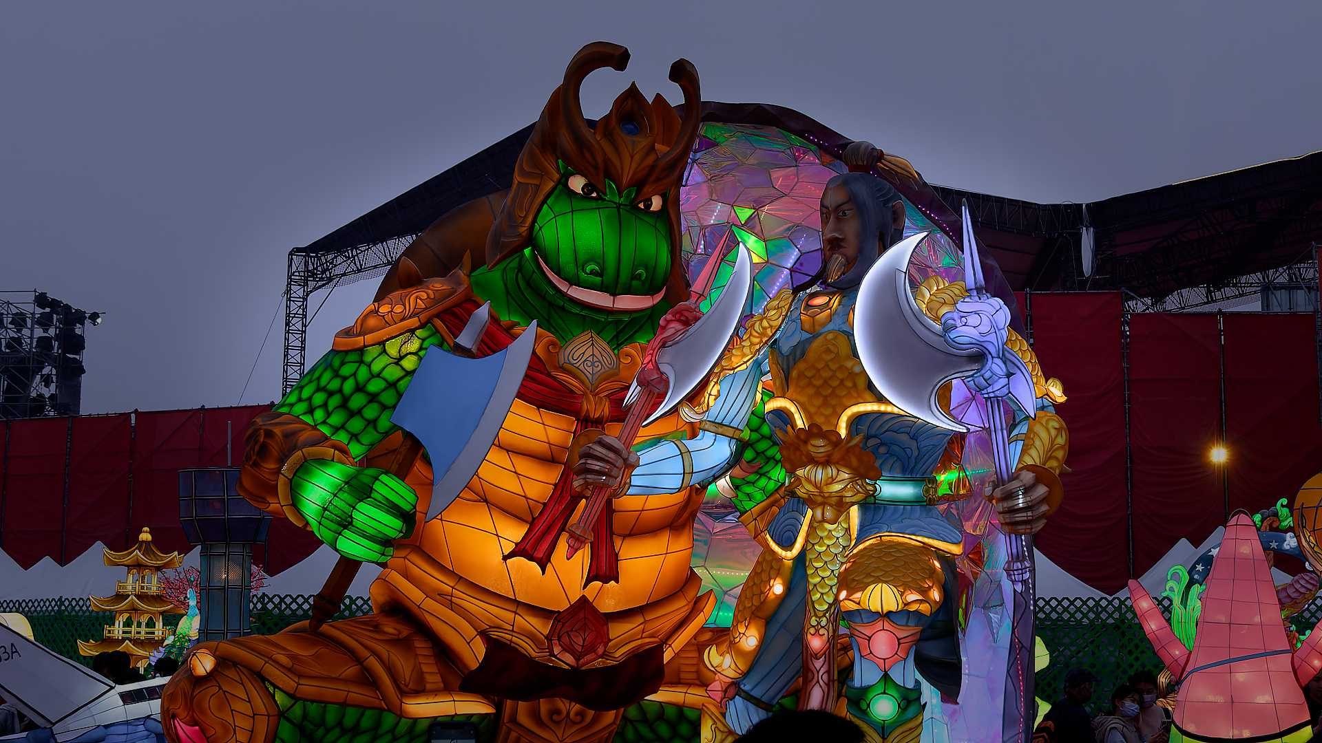 Lantern in the shape of a standing folklore beast and a man, both holding fighting weapons.