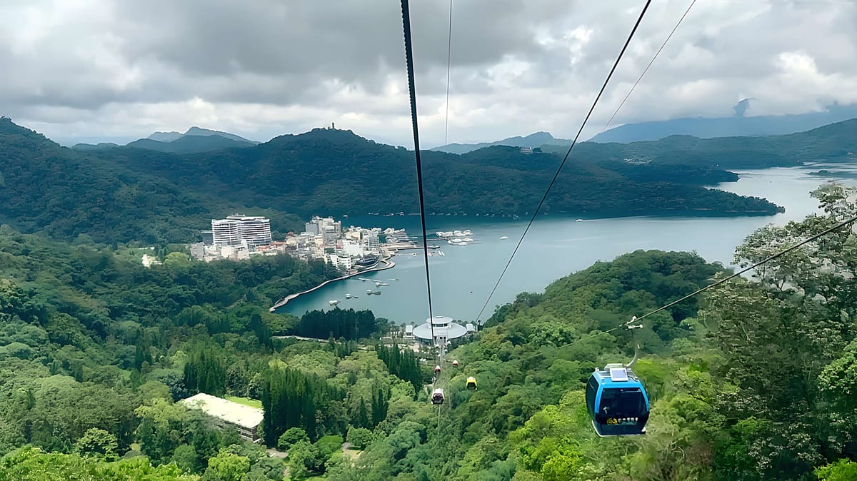 Aerial view of Riyue Village and Sun Moon Lake, with the Sun Moon Lake Ropeway gondola in the foreground.